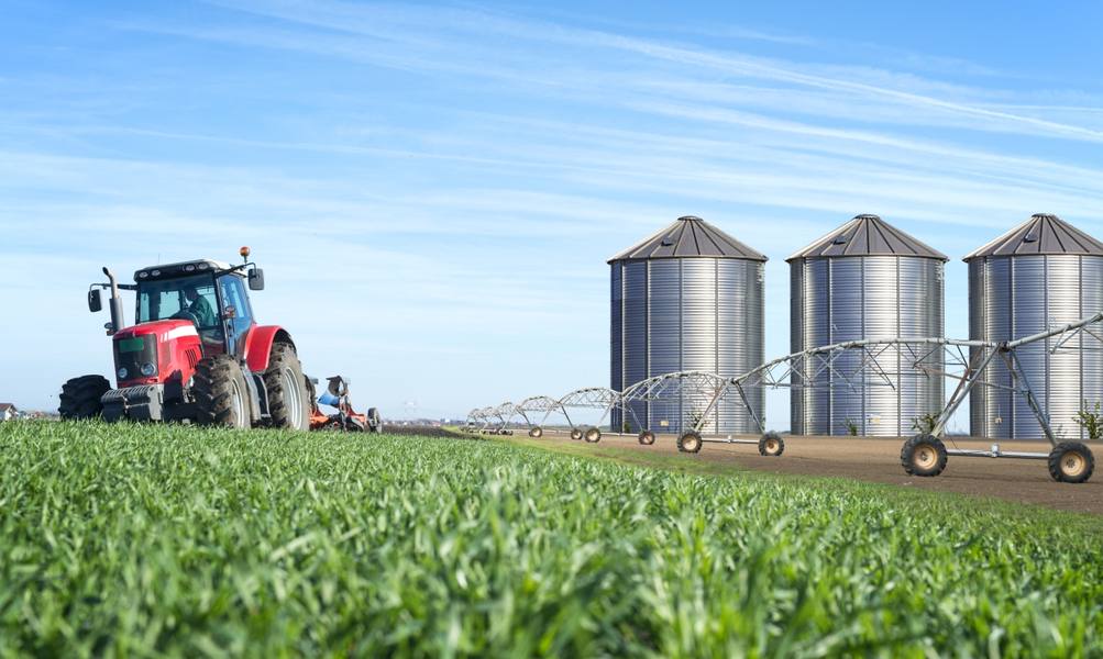 agriculture-food-production-concept-with-tractor-machine-silos-irrigation-system