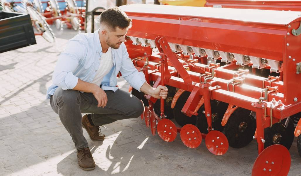 agronomist-choosing-new-planter-man-outdoor-ground-shop-agricultural-machinery