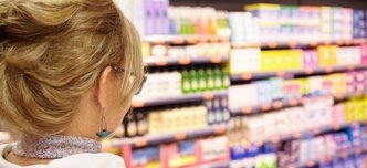 back-shot-grandmother-with-blonde-hair-shopping-local-supermarket-pushing-cart-forward-going-household-chemistry