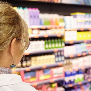 back-shot-grandmother-with-blonde-hair-shopping-local-supermarket-pushing-cart-forward-going-household-chemistry