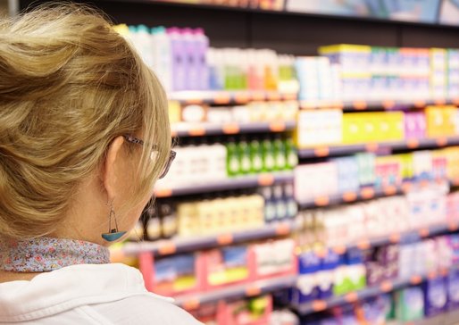 back-shot-grandmother-with-blonde-hair-shopping-local-supermarket-pushing-cart-forward-going-household-chemistry