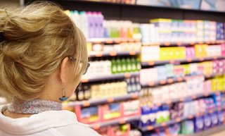 back-shot-grandmother-with-blonde-hair-shopping-local-supermarket-pushing-cart-forward-going-household-chemistry