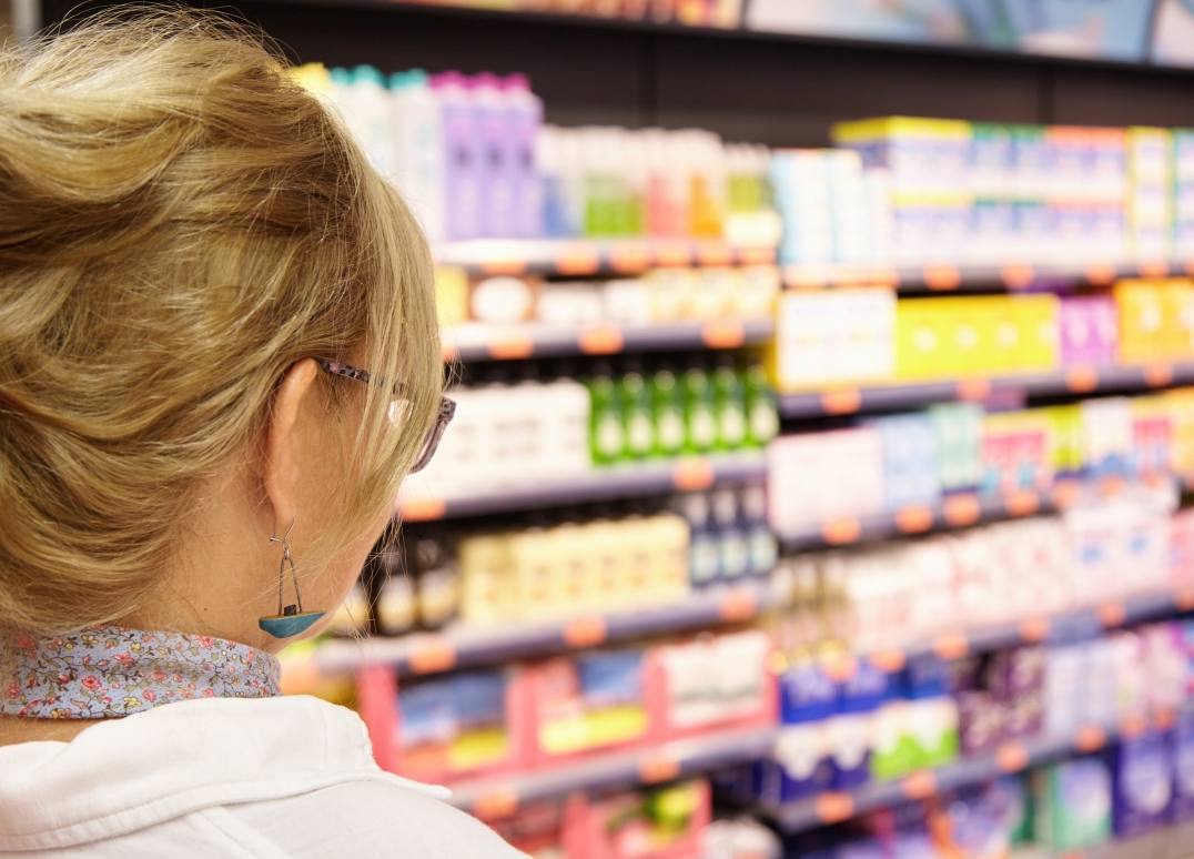 back-shot-grandmother-with-blonde-hair-shopping-local-supermarket-pushing-cart-forward-going-household-chemistry