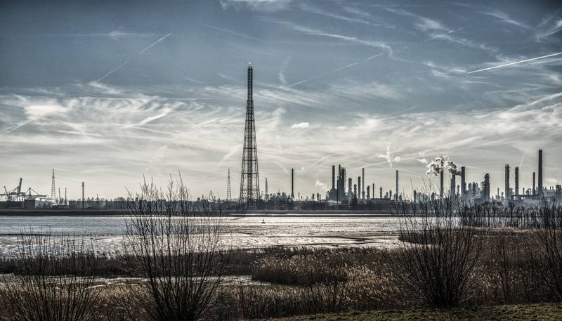 beautiful-scenery-industrial-buildings-shore-surrounded-by-grass-breathtaking-sky