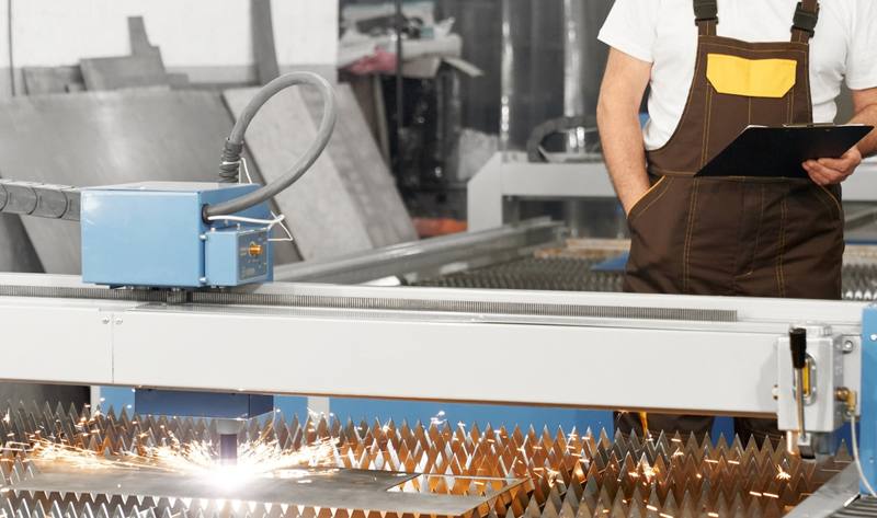 engineer-observing-plasma-laser-cutting-metal-sheet