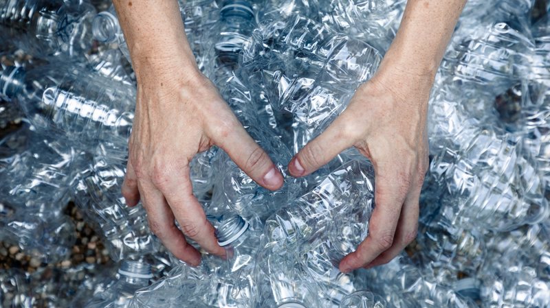 femals-hands-grabbing-plastic-bottles-collect-trash-them