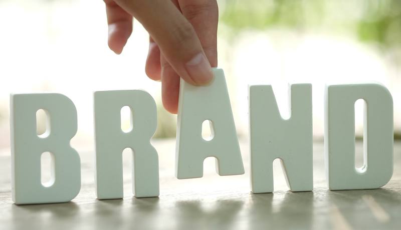 hand-arrange-white-letters-brand