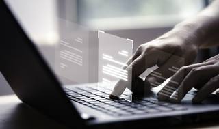 hand-using-laptop-computer-with-virtual-screen-document-online-approve-paperless-quality-assurance-erp-management-concept