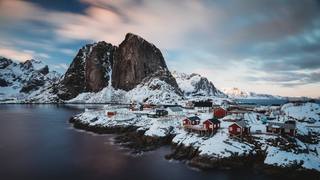 horizontal-shot-shore-town-with-red-houses-near-sea-snowy-mountain-back