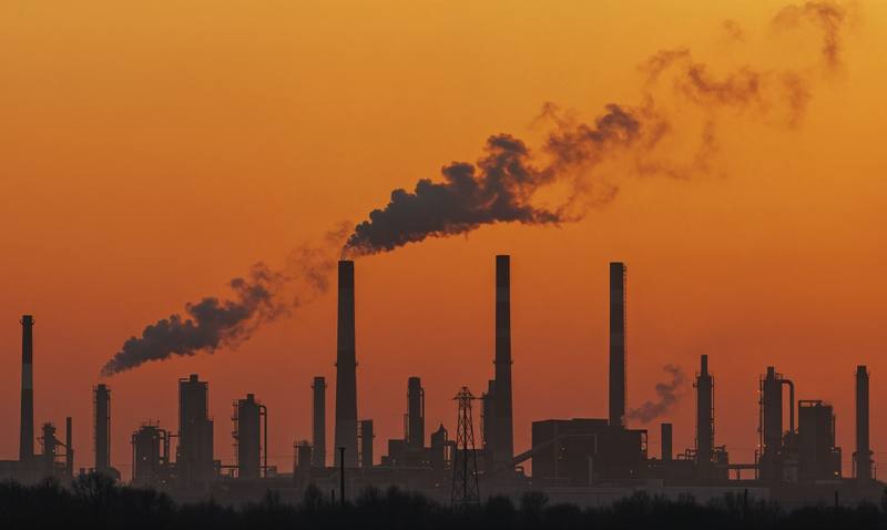 industrial-skyline-silhouetted-against-sunset-sky