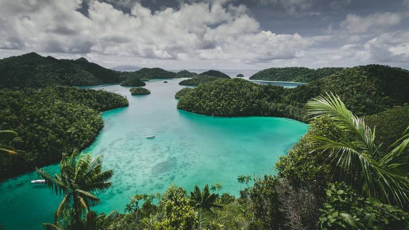 landscape-wajag-island-surrounded-by-sea-cloudy-sky-indonesia