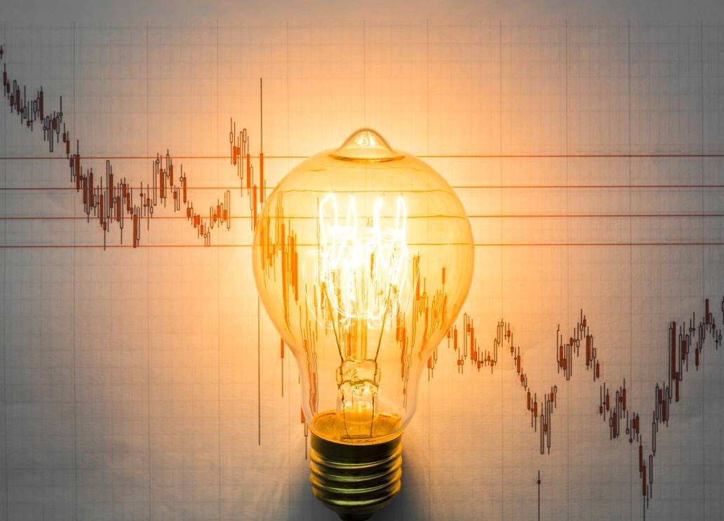 lit-light-bulb-with-graph-background