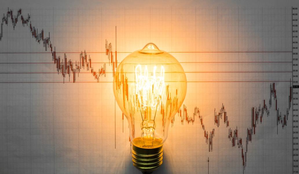 lit-light-bulb-with-graph-background