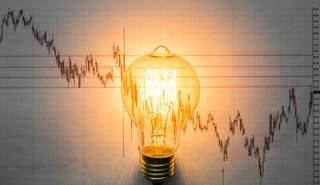 lit-light-bulb-with-graph-background