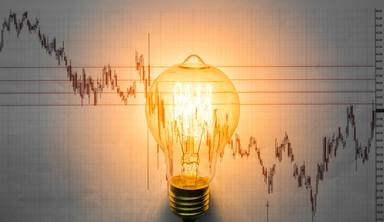lit-light-bulb-with-graph-background