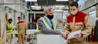 mid-adult-engineer-male-worker-wearing-face-masks-while-examining-paperwork-woodworking-factory-1028x615