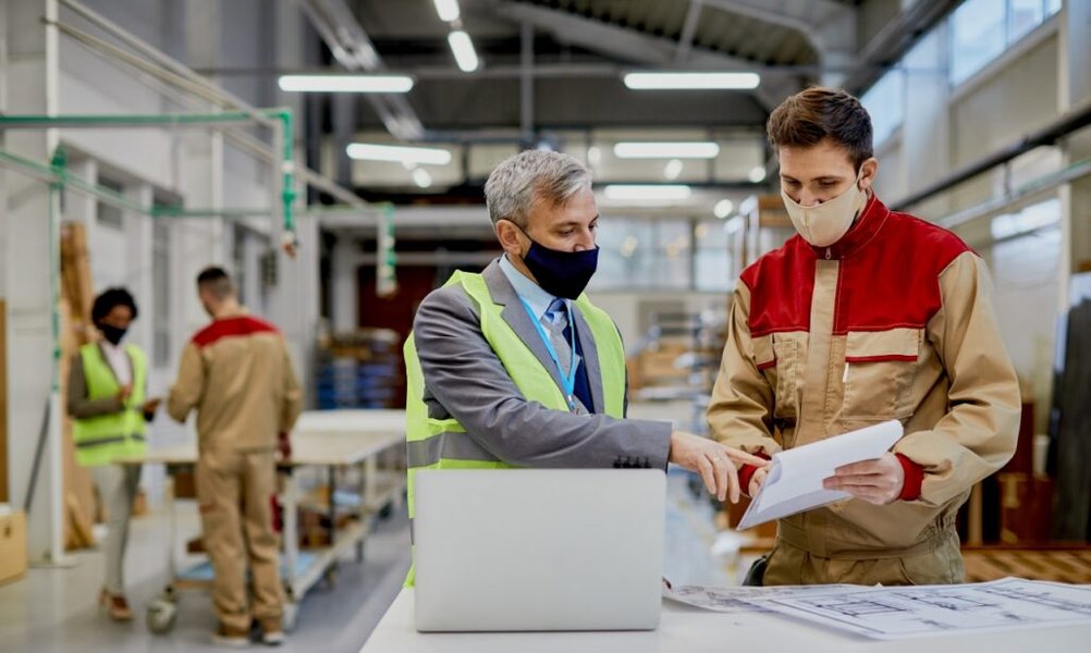 mid-adult-engineer-male-worker-wearing-face-masks-while-examining-paperwork-woodworking-factory-1028x615