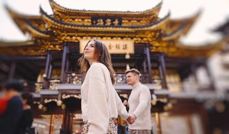 newlywed-couple-showing-affection-holding-hands-shanghai-near-yuyuan-while-visiting-china
