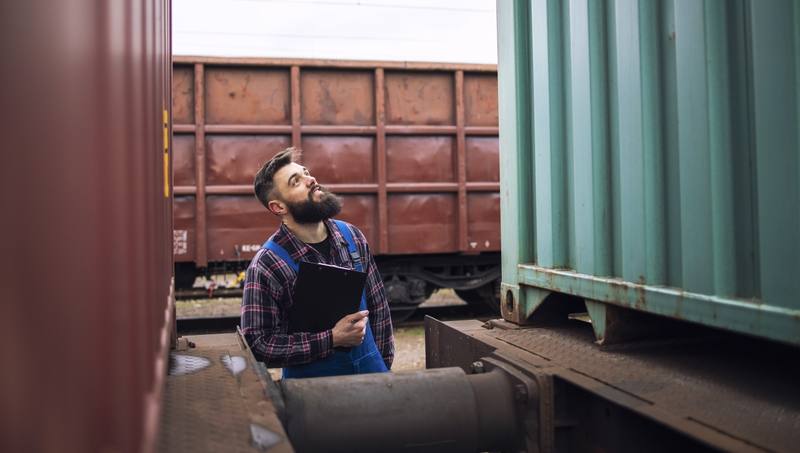 railroad-worker-supervisor-inspecting-shipping-cargo-container-freight-train-station