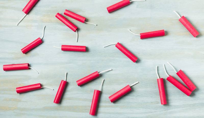 red-dynamite-firecrackers-blue-wooden-textured-background