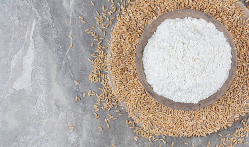 wooden-bowl-with-flour-oat-grains-marble-surface