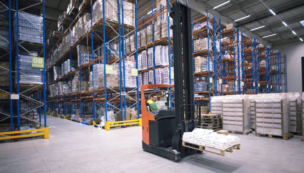 worker-operating-forklift-machine-relocating-goods-large-warehouse-center