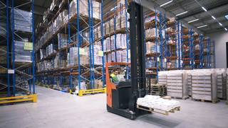 worker-operating-forklift-machine-relocating-goods-large-warehouse-center