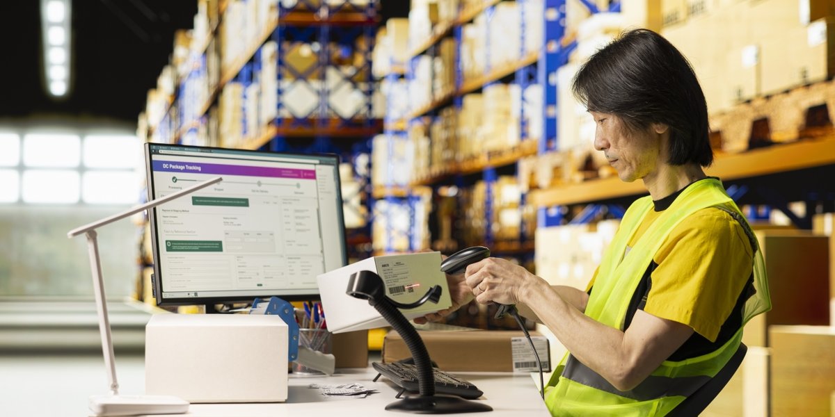 wp-586503b74a5e6424-asian-depot-worker-scanning-barcodes-packages-warehouse-reviewing-shipping-label