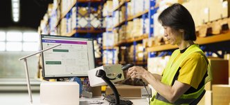wp-586503b74a5e6424-asian-depot-worker-scanning-barcodes-packages-warehouse-reviewing-shipping-label