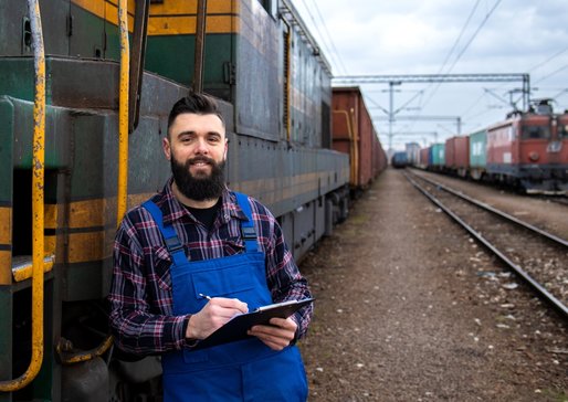 wp-7f72834bcc95f5dd-portrait-engine-train-driver-standing-by-locomotive-train-station-holding-depart