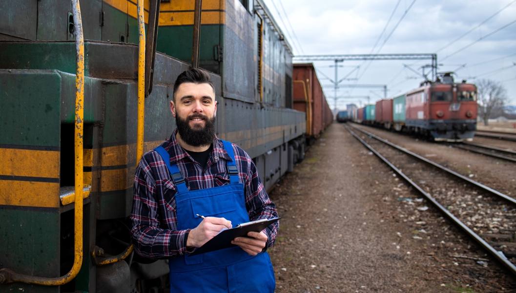 wp-7f72834bcc95f5dd-portrait-engine-train-driver-standing-by-locomotive-train-station-holding-depart