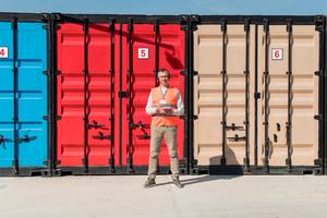 wp-94220880849347a9-full-shot-man-near-storage-units