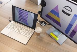wp-9722e3e61d827a27-Laptop,And,Monitor,Displaying,Colorful,Vr,Graphs,On,Wooden,Desk