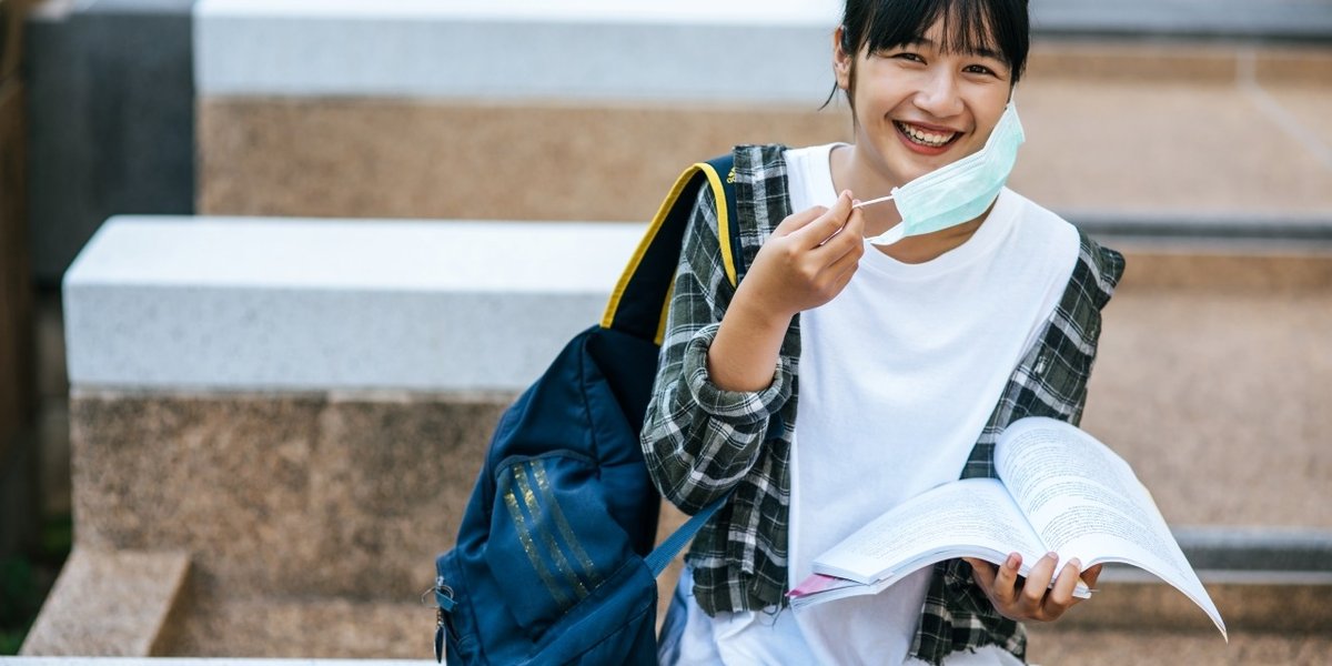 wp-a74e155cdd8ef55c-female-student-sitting-stairs-read-book