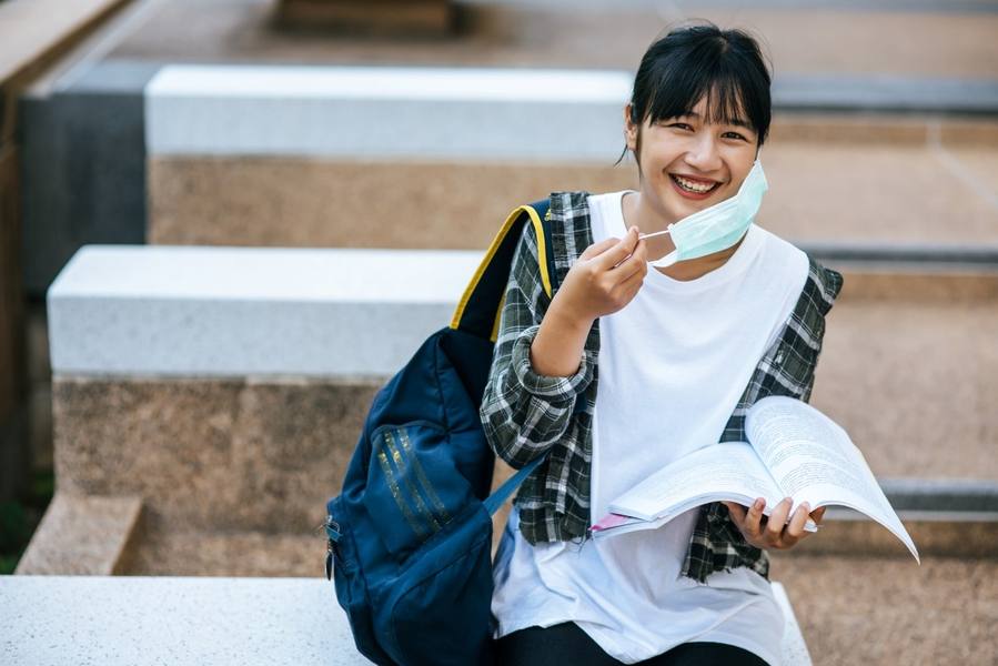 wp-a74e155cdd8ef55c-female-student-sitting-stairs-read-book