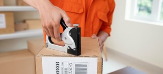 wp-d073671527feea8c-close-up-courier-preparing-package-delivery