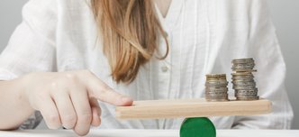 wp-d44ed5274ccd6131-woman-holding-her-finger-balance-with-coins