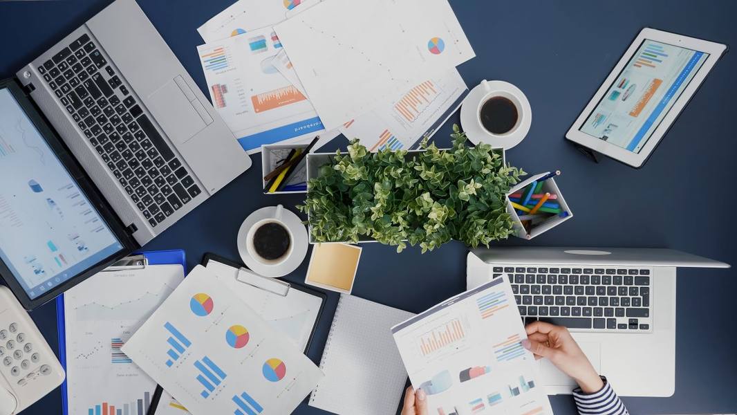 wp-f0a51b606a902025-top-view-manager-woman-analyzing-financial-paperwork-strategy-typing-expertise-l