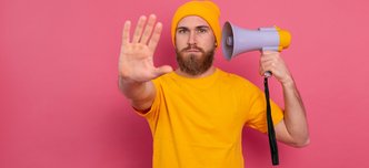 wp-fc9660756ec6fb30-european-man-hold-megaphone-show-stop-sign-pink-background