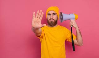 wp-fc9660756ec6fb30-european-man-hold-megaphone-show-stop-sign-pink-background
