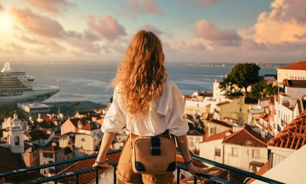 young-female-standing-platform-surrounded-by-fences-observing-lisbon-daytime-portugal