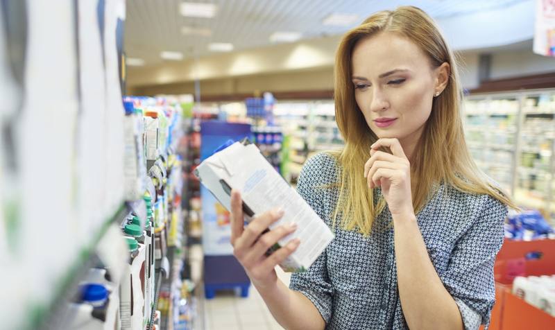 young-woman-reading-label-milk